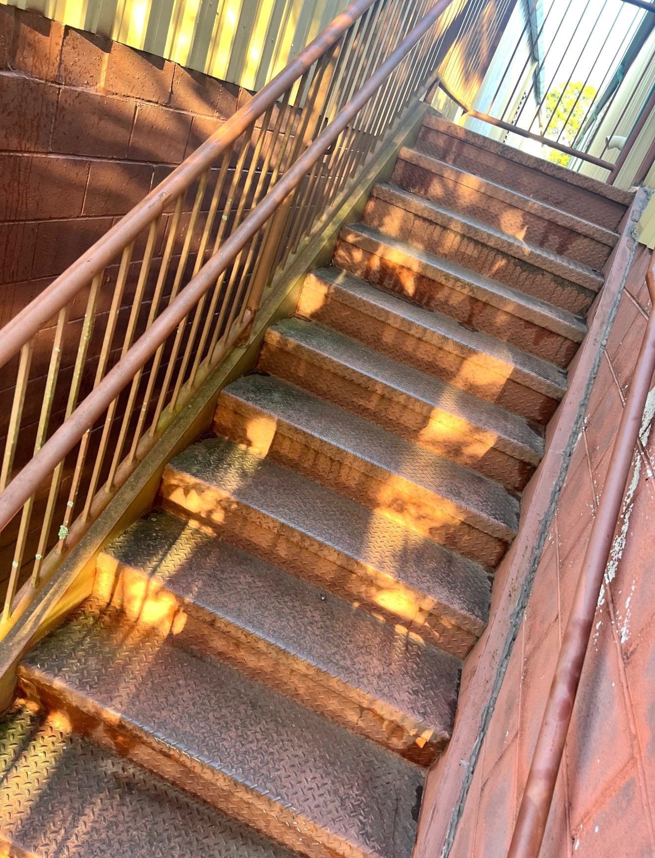 Rusted metal exterior staircase before repainting